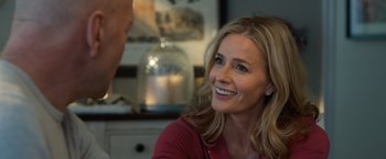 Movie still from “Death Wish” (2018), directed by Eli Roth – A woman smiling at the camera while sitting at a table; Close Up shot, Over the shoulder angle