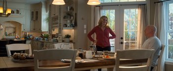 Movie still from “Death Wish” (2018), directed by Eli Roth – A woman standing at a table in the middle of a room; Wide shot, Over the shoulder angle