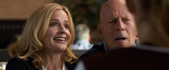 Movie still from “Death Wish” (2018), directed by Eli Roth – A woman and a bald headed man looking up at the sky; Close Up shot, Over the shoulder angle