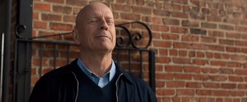 Movie still from “Death Wish” (2018), directed by Eli Roth – A bald headed man with his eyes wide open; Close Up shot, Low angle