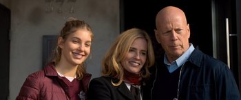 Movie still from “Death Wish” (2018), directed by Eli Roth – A woman and two men standing next to each other in front of a building; Medium shot, High angle