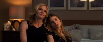 Movie still from “Death Wish” (2018), directed by Eli Roth – A woman sitting next to another woman in a room; Close Up shot, Low angle