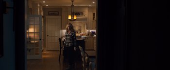 Movie still from “Death Wish” (2018), directed by Eli Roth – A woman standing in the middle of a kitchen; Wide shot, Over the shoulder angle