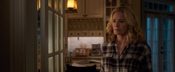 Movie still from “Death Wish” (2018), directed by Eli Roth – A woman standing in a kitchen next to a window; Medium shot, Over the shoulder angle