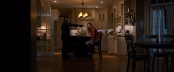 Movie still from “Death Wish” (2018), directed by Eli Roth – A man and a woman sitting at a table in a kitchen; Wide shot, Low angle