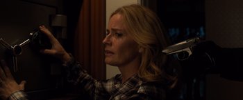 Movie still from “Death Wish” (2018), directed by Eli Roth – A woman with blonde wavy hair and a plaid shirt crying; Close Up shot, Over the shoulder angle