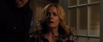 Movie still from “Death Wish” (2018), directed by Eli Roth – A woman with long blonde hair and a plaid shirt; Close Up shot, Over the shoulder angle