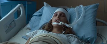 Movie still from “Death Wish” (2018), directed by Eli Roth – A woman laying in a hospital bed with a bandage on her head; Close Up shot, Overhead angle