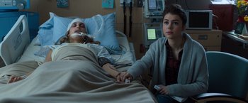 Movie still from “Death Wish” (2018), directed by Eli Roth – A woman is holding the hand of a man in a hospital bed; Close Up shot, Over the shoulder angle
