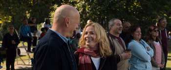 Movie still from “Death Wish” (2018), directed by Eli Roth – A man and a woman smiling at each other in front of trees; Close Up shot, Over the shoulder angle