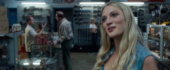 Movie still from “Death Wish” (2018), directed by Eli Roth – A woman with long blonde hair standing in a room; Close Up shot, Over the shoulder angle