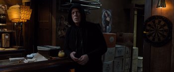 Movie still from “Death Wish” (2018), directed by Eli Roth – An older man wearing a black hooded sweatshirt; Medium shot, Over the shoulder angle