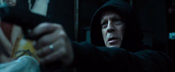 Movie still from “Death Wish” (2018), directed by Eli Roth – A man wearing a black hooded jacket and a ring; Close Up shot, Low angle