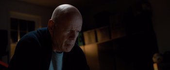 Movie still from “Death Wish” (2018), directed by Eli Roth – A man with a bald head looking to his left; Close Up shot, Low angle