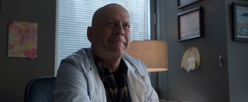 Movie still from “Death Wish” (2018), directed by Eli Roth – A bald man wearing a white shirt and a tie; Close Up shot, Low angle