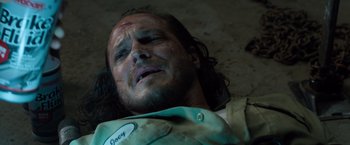 Movie still from “Death Wish” (2018), directed by Eli Roth – A man laying on the ground with his head in his hands; Close Up shot, High angle