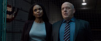 Movie still from “Death Wish” (2018), directed by Eli Roth – A man and a woman standing next to each other in front of a fence; Medium shot, Low angle