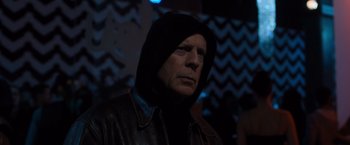 Movie still from “Death Wish” (2018), directed by Eli Roth – A man wearing a hooded jacket in a dark room; Close Up shot, Low angle