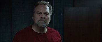 Movie still from “Death Wish” (2018), directed by Eli Roth – A person wearing a red shirt; Close Up shot, Low angle