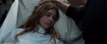 Movie still from “Death Wish” (2018), directed by Eli Roth – A woman laying in a hospital bed with her eyes closed; Close Up shot, Over the shoulder angle
