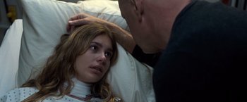 Movie still from “Death Wish” (2018), directed by Eli Roth – A man touching the forehead of a young woman; Close Up shot, Over the shoulder angle