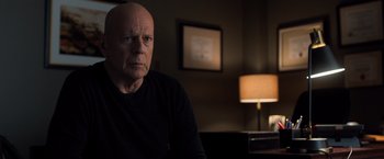 Movie still from “Death Wish” (2018), directed by Eli Roth – An older man sitting in front of a lamp in a dark room; Close Up shot, Over the shoulder angle