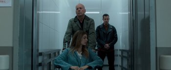 Movie still from “Death Wish” (2018), directed by Eli Roth – Two men and a woman standing in a room; Medium shot, Low angle