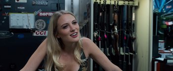 Movie still from “Death Wish” (2018), directed by Eli Roth – A beautiful blonde woman smiling for the camera; Close Up shot, Over the shoulder angle
