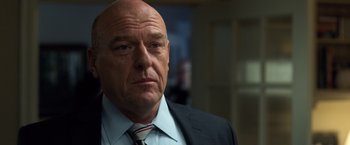 Movie still from “Death Wish” (2018), directed by Eli Roth – An older man in a suit and tie looking at the camera; Close Up shot, Low angle