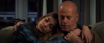 Movie still from “Death Wish” (2018), directed by Eli Roth – A man and a woman snuggling on a couch; Close Up shot, Over the shoulder angle