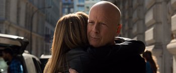 Movie still from “Death Wish” (2018), directed by Eli Roth – A man and a woman hugging each other in the street; Close Up shot, Over the shoulder angle