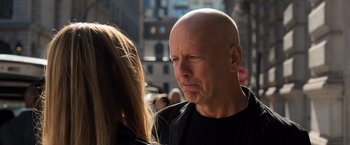 Movie still from “Death Wish” (2018), directed by Eli Roth – A man with a shaved head and a woman with long blonde hair; Close Up shot, Over the shoulder angle