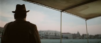 Movie still from “Death in Venice” (1971), directed by Luchino Visconti – A man standing under an awning looking out over a body of water; Close Up shot, Over the shoulder angle
