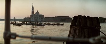 Movie still from “Death in Venice” (1971), directed by Luchino Visconti – A group of people on boats in a body of water; Extreme Wide shot, Low angle