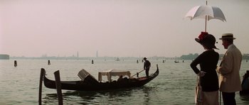 Movie still from “Death in Venice” (1971), directed by Luchino Visconti – A gondolier in the water with his boat in the background; Extreme Wide shot, High angle