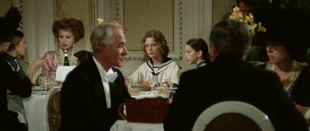 Movie still from “Death in Venice” (1971), directed by Luchino Visconti – A group of people sitting around a table; Medium shot, Over the shoulder angle