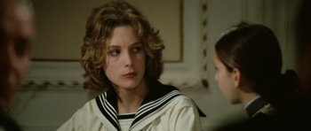 Movie still from “Death in Venice” (1971), directed by Luchino Visconti – A young girl in a sailor's outfit looks at the camera while a younger girl looks on; Close Up shot, Over the shoulder angle