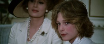 Movie still from “Death in Venice” (1971), directed by Luchino Visconti – A woman sitting next to another woman in a room; Close Up shot, Over the shoulder angle