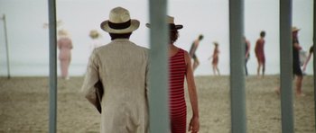 Movie still from “Death in Venice” (1971), directed by Luchino Visconti – Two people standing on the beach looking at the ocean; Close Up shot, Over the shoulder angle