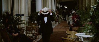 Movie still from “Death in Venice” (1971), directed by Luchino Visconti – A man in a suit and a white hat; Medium shot, Over the shoulder angle