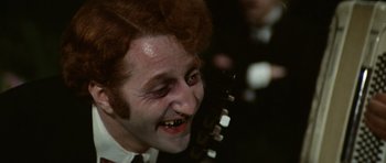 Movie still from “Death in Venice” (1971), directed by Luchino Visconti – A person with a face painting; Close Up shot, High angle