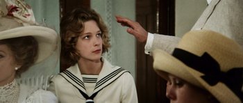 Movie still from “Death in Venice” (1971), directed by Luchino Visconti – A woman in a sailor suit is looking at a man in a hat; Close Up shot, Over the shoulder angle