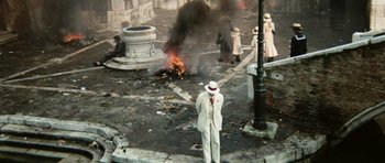 Movie still from “Death in Venice” (1971), directed by Luchino Visconti – A man in a white hat standing in front of a fire; Wide shot, High angle