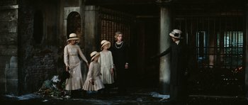 Movie still from “Death in Venice” (1971), directed by Luchino Visconti – A group of people standing next to each other on a stage; Wide shot, High angle