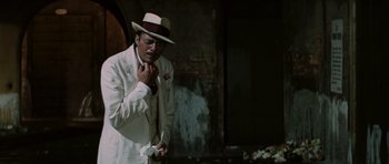 Movie still from “Death in Venice” (1971), directed by Luchino Visconti – A man in a white suit and a white hat; Medium shot, Low angle