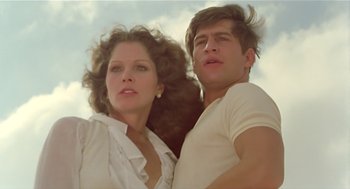 Movie still from “Death on the Nile” (1978), directed by John Guillermin – A man and a woman posing for a picture; Medium shot, Low angle