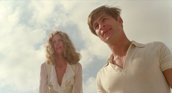 Movie still from “Death on the Nile” (1978), directed by John Guillermin – A man and a woman standing next to each other in front of the sky; Medium shot, Low angle