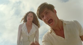 Movie still from “Death on the Nile” (1978), directed by John Guillermin – A man and a woman in a white dress; Medium shot, Low angle