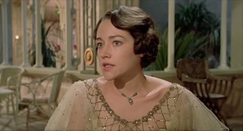 Movie still from “Death on the Nile” (1978), directed by John Guillermin – A person wearing a dress; Close Up shot, Over the shoulder angle