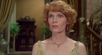 Movie still from “Death on the Nile” (1978), directed by John Guillermin – A person wearing a necklace; Close Up shot, Over the shoulder angle